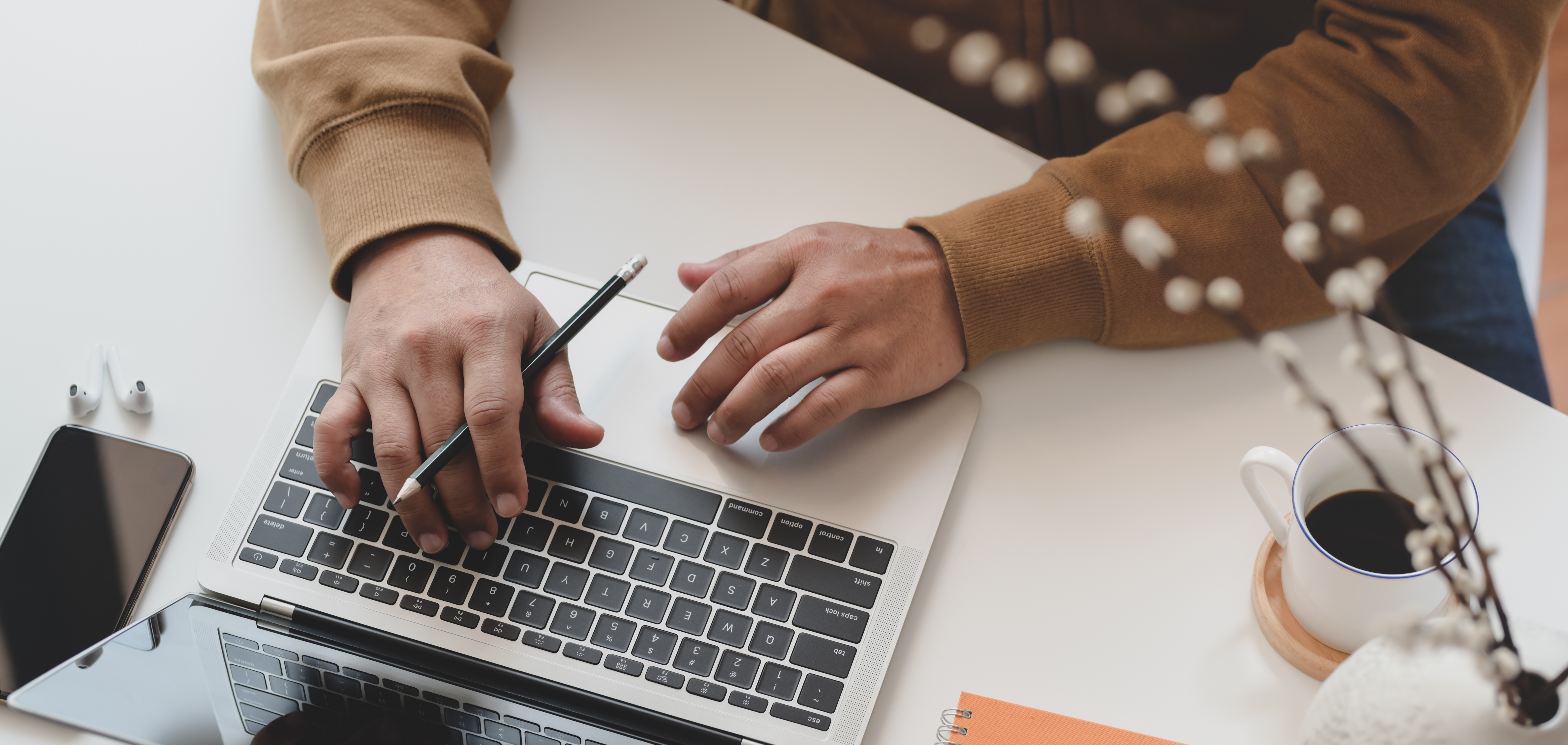 person-in-brown-long-sleeve-shirt-using-macbook-pro-3787293.jpg